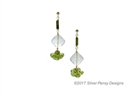 A unique drop Earring hand crafted in the U.S. by Silver Pansy. Dark Green Tourmaline beads lead the way with a diamond drop of soft Green Praisiolite, followed by a Green Peridot Gemstone. Gold Filled Sterling Silver wire & Posts.