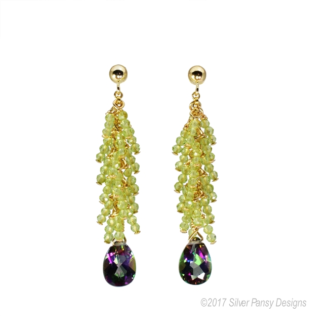 Beautiful, hand crafted drop Earrings. Green Peridot Gemstones create a feather affect above the Mystic Topaz Gemstone drop - filled with the reflective colors of the Sea. Made in the U.S. by Silver Pansy. Gold Filled Sterling wire & posts.