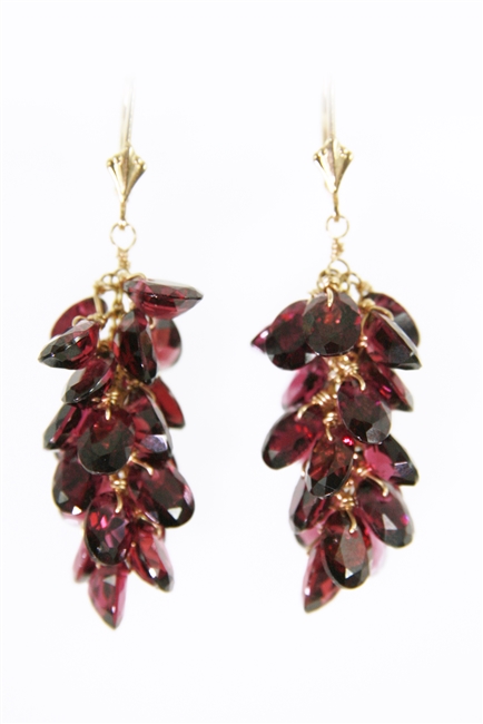 Beautiful Red Rhodolite Garnet cluster drop Earrings. A multitude of faceted gemstones descend from the lever backs. Made in 14k Yellow Gold. 24.70ctw, 1 3/4 inch long.