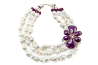 Beautiful Triple Strand White Baroque Pearl Necklace with a large, attached, Flower Pendant in African Rubies with Diamond accents. This designer Necklace was made in Italy by Rajola. 18K Yellow Gold. One of a kind.