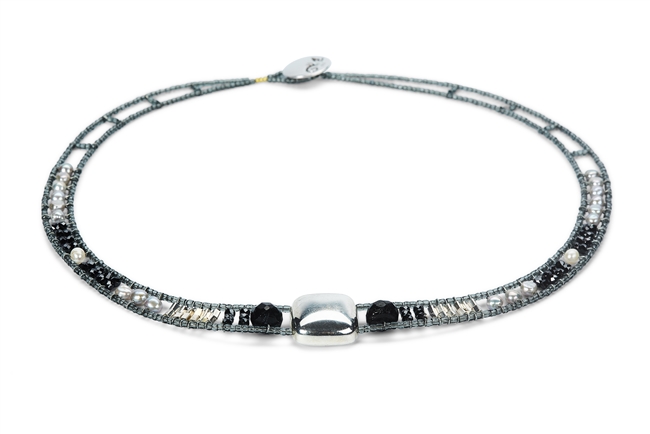 Necklace features a large, square Sterling Silver Bead at the center. The neck band is in Black Tourmaline & Zirconia Gemstones, Grey Pearls & Silver Beads. Hand crafted in Italy it is on Stainless Steel wire with Grey Murano Glass seed Beads.