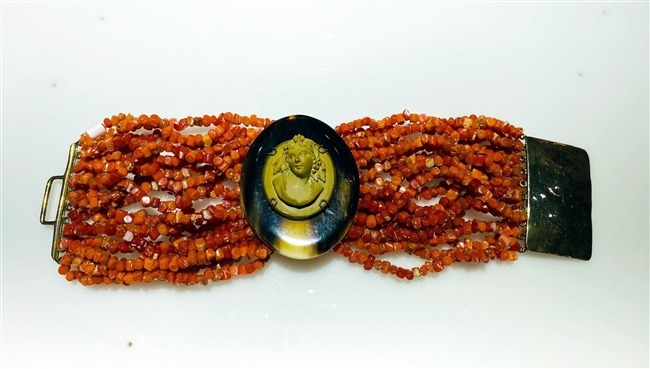 One-of-a-kind designer Cuff Bracelet by Amle.  Hand crafted in Italy, this statement bracelet features multi-strands of Coral Gemstone Beads with a Horn medallion at the center embellished with an antique Cameo. Latch clasp. Width 2 1/2 inches