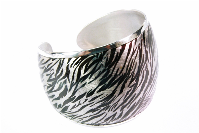 This wide, 925 Sterling Silver Cuff Bracelet has a two-tone Enameled overlay. The finish is a silver and black Zebra look. A very subtle Animal print that adds a contemporary style. Made in Italy by Claudio Faccin. Size Medium