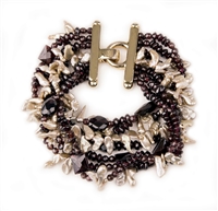 This seven strand Bracelet boasts mixed sizes of Ruby Red Garnets, mixed with Pink Kashi Pearls. A beautiful, complimenting blend. Made in Italy by Mattio Mazza. Yellow Gold plated Sterling Clasp with locking latch. Length 7 1/2", Width 1 1/2"