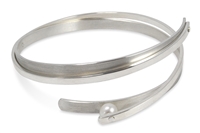 Try this twisted Sterling Silver Cuff Bracelet for a fun, contemporary look. Two solid Bands of Sterling wrap around each other and hold a single Grey 6mm Pearl at one end. Rhodium plated. By designer Martha Seely