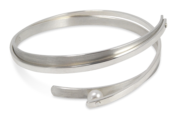 Try this twisted Sterling Silver Cuff Bracelet for a fun, contemporary look. Two solid Bands of Sterling wrap around each other and hold a single Grey 6mm Pearl at one end. Rhodium plated. By designer Martha Seely