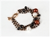 Multi-strand 18k Rose Gold Bracelet by Zoccai. Various sizes of Black Onyx Beads, two White Pearls and two Bronze Pearls add color and style. This is a classic with Italian style. Made in Italy. Lobster Clasp. Pearls are aprox. 11mm