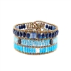 From Ziio's Fenice Collection - this Cuff Bracelet features a medley of Blue Gemstones. Blue Lapis, Kyanite & Zircon Gemstones are accented with Black Spinel & White Pearls in this linear design. Made with Murano Glass Beads on Stainless Steel Wire.