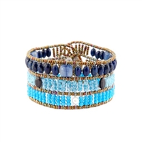 From Ziio's Fenice Collection - this Cuff Bracelet features a medley of Blue Gemstones. Blue Lapis, Kyanite & Zircon Gemstones are accented with Black Spinel & White Pearls in this linear design. Made with Murano Glass Beads on Stainless Steel Wire.