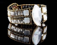 Ziio's Marquise Cuff Bracelet with a large White, opalescent Mother of Pearl  at the center surrounded by additional Pearl beads, Sterling Silver Beads. Black Onyx Gemstones add contrast at the back. Made in Italy on stainless steel wire