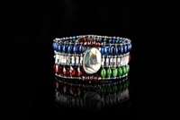 A stunning Bracelet from Ziio's Extraordinaire Collection. The rich color combination of Red Garnet, Blue Lapis & Green Jade gemstones glows next to the Sterling Silver Beads. It is hi-lighted with an Abalone Shell at the center and accented with Onyx