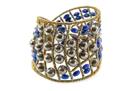 Beauty is in the simplicity of this statement Cuff Bracelet by Ziio. Hand crafted in Italy, features the contrast of Pyrite Beads with Blue Lapis Gemstones. Beaded on Stainless Steel wire with Golden Murano Glass seed beads. Sterling Silver Button closure