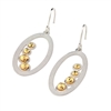 Two-tone Oval Drop Earring by Frederic Duclos. The Oval Hoop has a Frosted White finish and is finished with a row of four Golden Beads inside. Hooks. 925 Sterling Silver. L 1 1/2" X W 5/8"