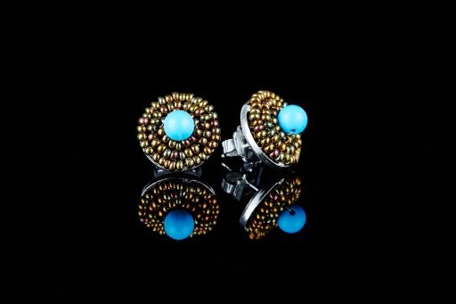 These Button Earrings by Ziio will make a wonderful addition to any wardrobe. A single Blue Magnesite Gemstone is surrounded by two rows of golden Murano Glass Beads. 925 Sterling Silver back & Post. Made in Italy. Dimension 5/8"