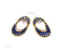 The oval Chandelier Earring compliments every face structure. Open at the center, the top is beaded with Blue Lapis Gemstones and has a single Lavender Amethyst Teardrop. The bottom is also in Lapis Beads nesting a single large White Baroque Pearl.