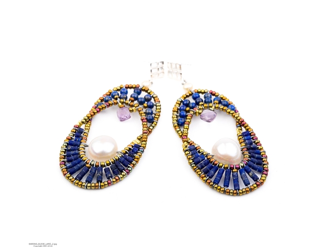 The oval Chandelier Earring compliments every face structure. Open at the center, the top is beaded with Blue Lapis Gemstones and has a single Lavender Amethyst Teardrop. The bottom is also in Lapis Beads nesting a single large White Baroque Pearl.