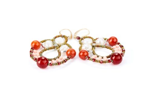 Galaxie chandelier Earrings are done in White Water Pearls, Red Agate Gemstones, Red Zirconia & imitation Coral Beads. Murano Glass Beads on Stainless Steel Wire create the design and shape.Gold plated 925 Sterling Silver Posts. L 2 3/4" X W 1 1/2"