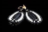 These chandelier Jet Earrings by Ziio are the perfect Black & White combination. A long matte Black Onyx Gemstone is at the center surrounded by the beautiful contrast of White Water Pearls. Beaded on stainless steel wire with Black Murano Glass Beads