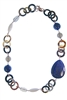 Natural tan & brown Horn Necklace by Amle. Asymmetrical in design, the collar Necklace is accented with Blue Lapis, Smokey Quartz & White Agate Gemstones in various shapes and sizes. Hand crafted in Italy in Rose Gold plated sterling silver chain & clasp