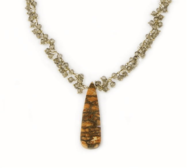 Tiny seed beads of Smokey Quartz Gemstones fill the Gold filled chain and hold a triangular Pendant of Petrified Coral. Made in the U.S. by Elisa Ilana. Adjustable in length from 16" to 18". Coral Pendant length 1 3/4"