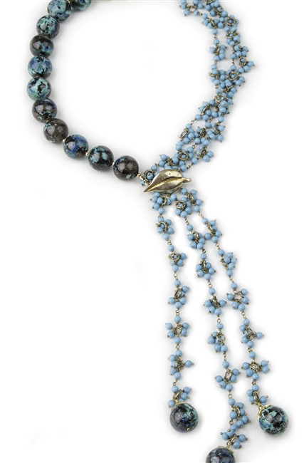 This Necklace is an award winning design by Elisa Ilana. One side has large (15-16mm) round polished Chrysocolla Beads. The other has 3 strands with Turquoise Bead clusters that fall to a Tassel, completed with additional Chrysocolla Beads. 925 Sterling