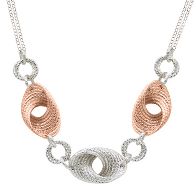 The movement & depth in this two-tone Cyclone Twist Necklace is amazing. Done in 925 Sterling Silver, accented with Rose Gold plating and laser cutting. Lobster Clasp. Double chain at the Neck. Length 18" to 20" adjustable.