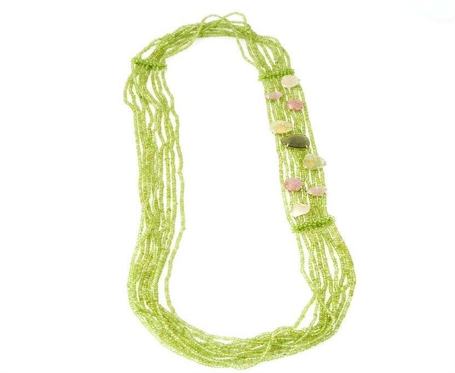 Multi-strands of faceted Green Peridot Gemstones create this long asymmetrical Necklace. The left side of the piece is adorned with what appear to be "floating" Gemstones of Pink & Yellow Sapphires & Green Tourmaline mounted in 18K Yellow Gold. 38" Lengt