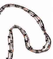 Long 3 strand Black Onyx Necklace filled with movement & visual interest. Each strand features different shapes & sizes of Onyx, Red Coral & Hematite Gemstones, sure to catch your eye. Made in Italy by Rajola. Fits over the head, no latch. Length 38"