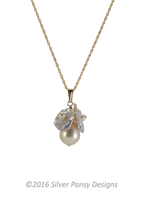 This Pendant Necklace features large, White, Fresh Water Pearl at the center framed at the top with three Keshi Pearl Chips. Each Chip has a White Seed Pearl at the center. Hand crafted by Silver Pansy. 18" Gold Filled Wheat Chain. Pendant is 1"L x 5/8"W