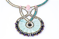 Statement Art-to-Wear Necklace by Ziio. Hand crafted in Italy, the Fluorite Gemstone center Pendant is surrounded by a row of small Black Onyx Beads accented with Amethyst Gemstones. The asymmetrical Neckline features Turquoise & White Water Pearls