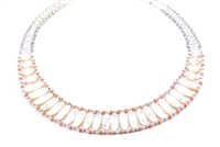 This Mother of Pearl Necklace is an Italian twist on your classic Pearl Necklace. Hand crafted in Italy by Ziio, it features a graduating band of polished, White Mother of Pearl beads, accented with soft pink Coral Beads. On stainless steel wire