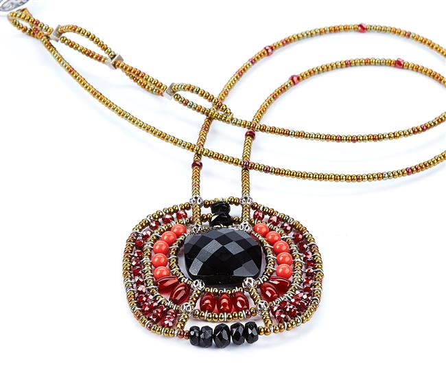 From Ziio's Twilight Collection. This striking Pendant Necklace has a Black Onyx Gemstone at the center, surround by multi-shades of Red & Black Gemstones. Garnet, Coral, Carnelian, Zircon, Tourmaline, Brass & Murano Glass Beads. Hand crafted in Italy.