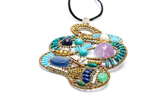 This striking, Limited Edition Pendant Necklace, called Mamba, features Blue Lapis, Kyanite & Turquoise Gemstones accented with a large Amethyst Gemstone bead and a White Pearl. Hand crafted on stainless steel wire with Golden Brass & Murano Glass Beads.