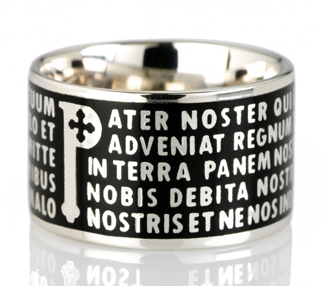 The Animae collection by Tuum is the Sterling Silver rhodium plated version of their ring creations. This is the "Pater" with the Pater Noster (Our Father) Latin text written in relief in over five lines. Crafted in 925 Sterling with black enamel overlay