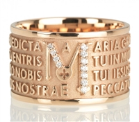 The collection TUAM is the next iteration of ORIGINE, with the Ave Maria Latin text written in relief over four lines. This Ring in 18kt Rose Gold is embellished by brilliant Diamonds concentrated on the â€œMâ€. Made in Italy