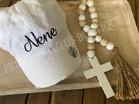 White distressed pony tail hat with black embroidery font