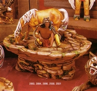 A scene of multiple cast ceramic pieces. The base is a large bowl on a stand, all shaped like rocks. A Native American man kneels in the center, arm reaching down into the water flowing around the bowl. There is a horse behind him, drinking the water.