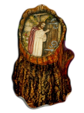 A cast ceramic slab depicting Jesus knocking at a wooden door set into a stone wall. The slab is set into the opening of a large cast ceramic tree stump.