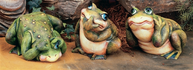Three separate frogs made of cast ceramic arranged in a line. The left leans forward, face to the ground, covering its eyes. The middle sits looking up with a hand covering its mouth. The right crouches looking forward, hands covering its ears.