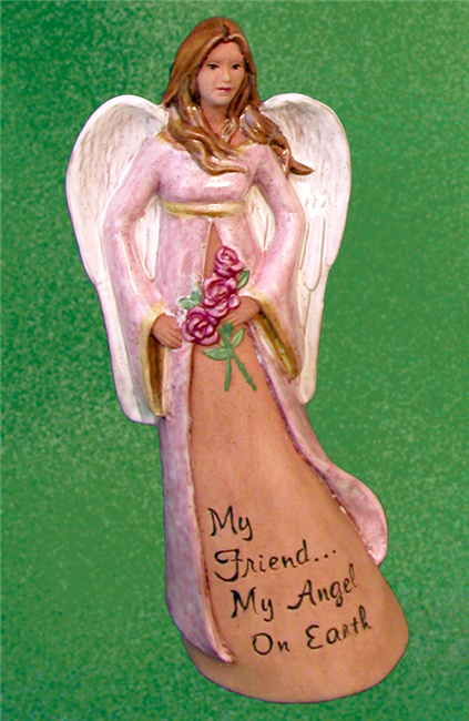 A cast ceramic figure of an angel. Their long hair blows to their left and they hold a bouquet of three roses in their hands in front of them. They wear a long flowing robe over a long dress with the words My Friend My Angel On Earth carved at the bottom