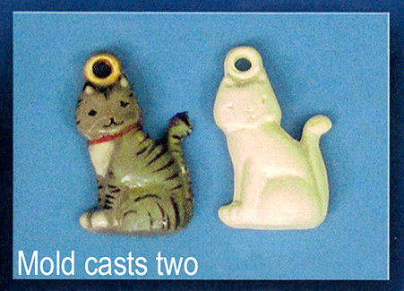 Two flat ornaments of cast ceramic. Both are shaped like the side profile of a seated cartoon cat with its head turned forward. There is a small ball with a hole in it atop its head for hanging. The left has been painted, the right has not.