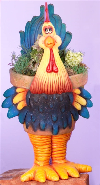 A large cast ceramic pot made of several pieces, assembled to look like a cartoonish rooster. Its body is the pot, textured with false cracks around the rim. Its long neck and tail come up above the rim, and its legs and feet support the bottom.