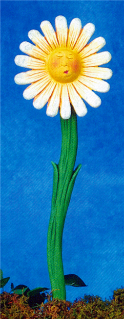A two part cast ceramic garden stake shaped like a flower with a cartoonish face. The slightly curved stem has two small protruding leaves. The flower has a face in the center with closed eyes and small lips in a smile. The petals are slightly separated.