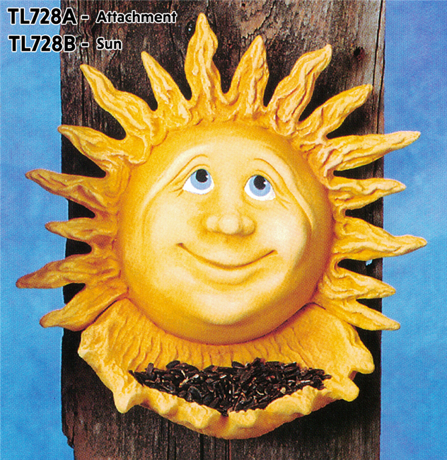A cast ceramic plaque of a three dimensional sun with a cartoonish face. It looks upwards with a calm smile. The rays under it, made of a separate piece of cast ceramic, are cupped like hands and filled with real seeds.