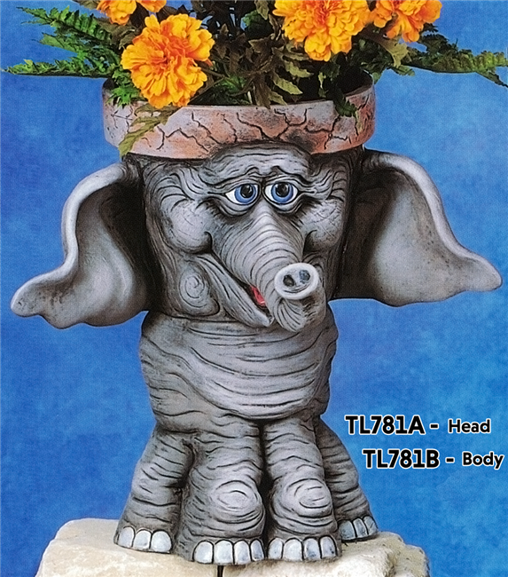 A multi part cast ceramic figure of a cartoonishly styled standing elephant. Its head is hollowed out and topped with a rim like a garden pot. Its large ears protrude from either side of the pot and its trunk curves forward. Its feet are wide.