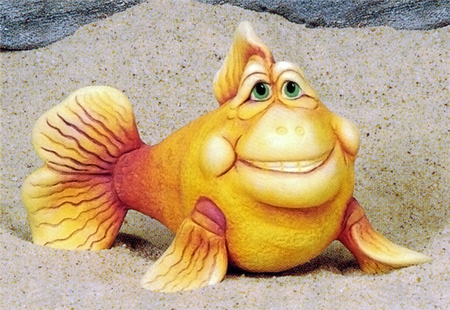 A cast ceramic figure of a cartoonishly styled fish with a humorous expression. It gazes upward with a toothy grin. It is posed with its tail slightly to one side and its pectoral fins against the ground in front of it, raising it slightly.