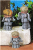 Three separate cast ceramic figures of cartoonishly styled standing elephants. Their heads are hollowed out and topped with rims like a garden pot. Each is a slightly different size, but all look forward happily.