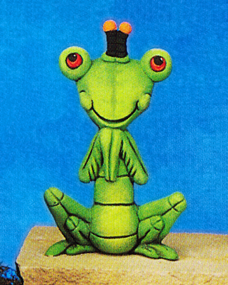 A cast ceramic figure of a cartoonish praying mantis. It sits on two pairs of bent back legs with its front pair of scythe like arms held cutely to its chest. Its large eyes are on either side of its head and it has a wide smile and two stocky antennae.