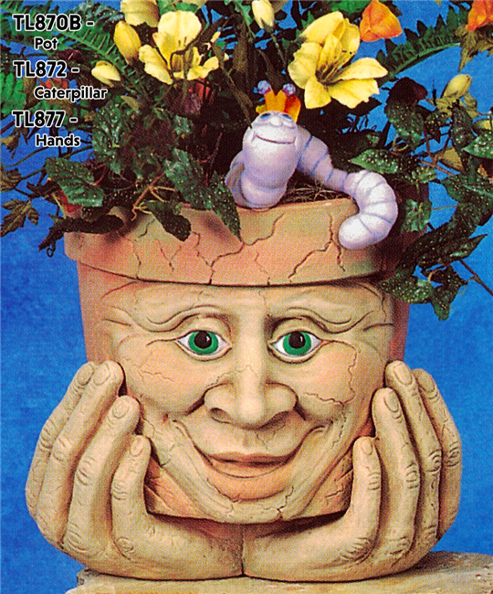 A cast ceramic pot with a cartoonish human face. The face has an open mouth smile, large nose, and lidded eyes. The pot is textured with small lines like aged cracks and is placed atop a pair of cartoonish cast ceramic hands as if it was holding its chin.