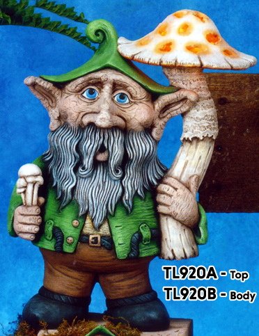 A cast ceramic figure made of multiple pieces assembled into a cartoonish gnome. He has a large nose and ears, a pointed cap, and long facial hair. He stands, holding a single very large mushroom in his left hand and a bundle of small ones in his right.